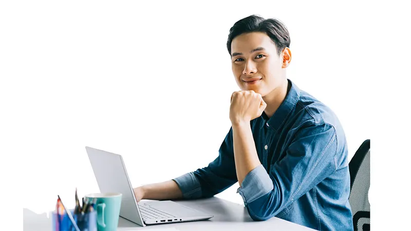Professional man at desk using laptop for variable insurance Philippines