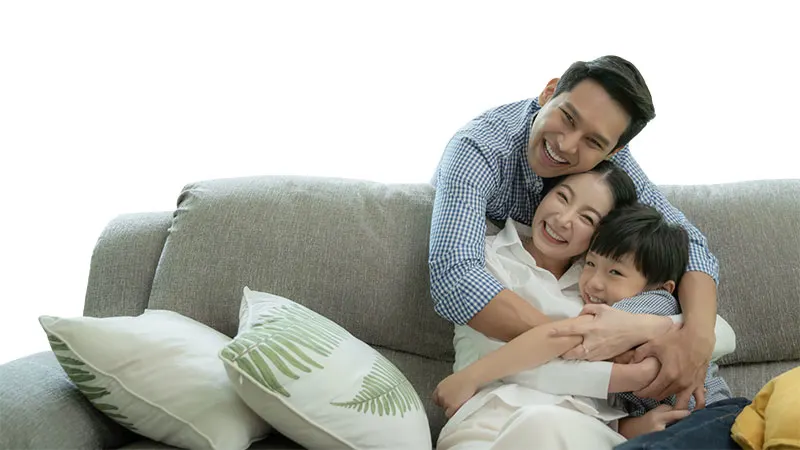 Happy family relaxing at home with variable life insurance Philippines Protection