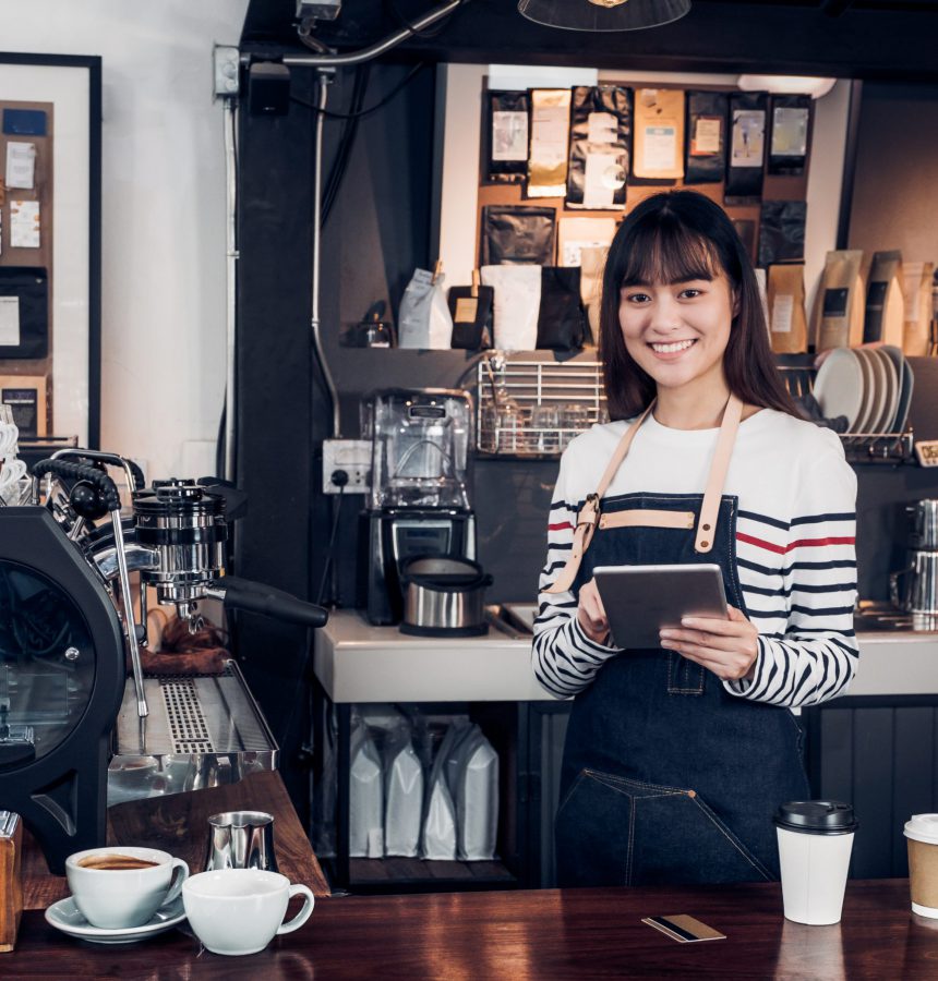 woman barista take order with tablet,asia female waitress using woman barista take order with tablet,asia female waitress using digital device in coffee shop business at counter bar in cafe,moder food owner business start up