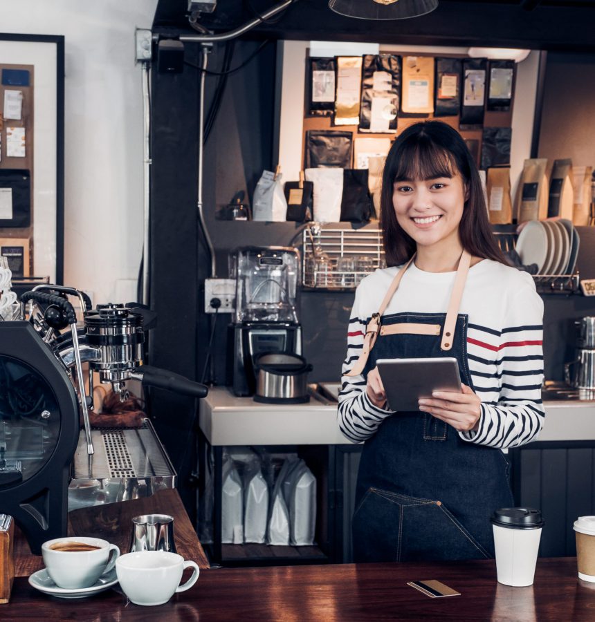 woman barista take order with tablet,asia female waitress using digital device in coffee shop business at counter bar in cafe,moder food owner business start up